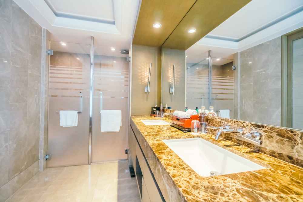 Modern bathroom with matte finish and textured vitrified tiles by GVT tile suppliers in India