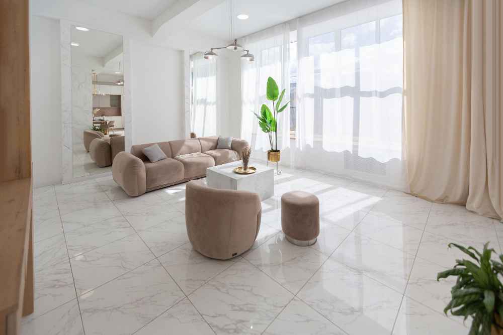 Minimalist living space with neutral-toned vitrified tiles by GVT tile suppliers in India.